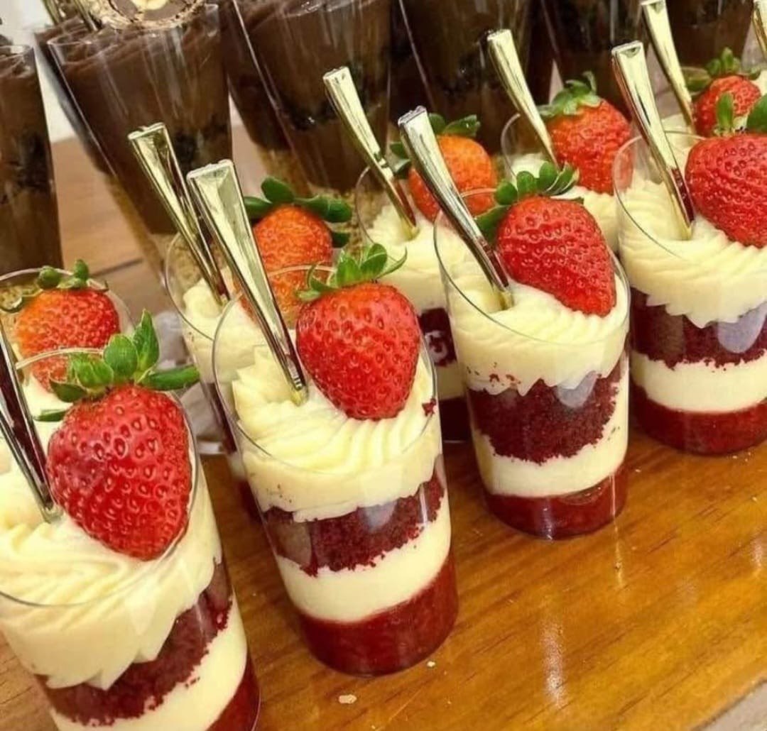Mesa de postres de catering con cupcakes, trifles y tartas